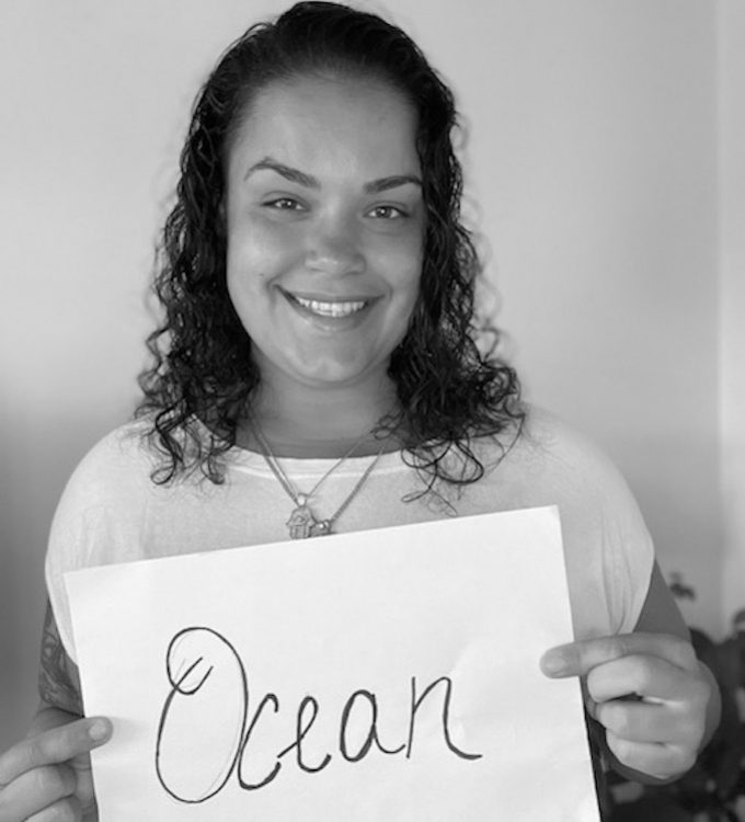 Stephanie Andujar photo holding sign that says ocean